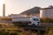 Tank truck circulating along a road with large fuel deposits