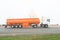 Tank truck, fuel carrier, on highway against a background of th