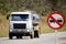 Tank truck and traffic sign indicating forbidden to overtake