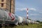 Tank wagons train from Nafta Industria Srbije passing near a factory chimney in an industrial district of capital city of Serbia