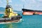 Tanker barge and powerful tugboats in sea