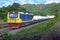 Tanker-freight train by diesel locomotive on the hillside railway.