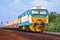 Tanker-freight train by diesel locomotive on the railway yard.