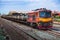 Tanker-freight train by diesel locomotive in the railway yard.