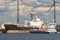 Tanker moored at petrochemical production plant with windmills, Port of Antwerp, Belgium