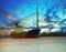 Tanker ship in river against beautiful bridge with twilight sky