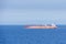 Tanker ship sailing through blue and calm Mediterranean Sea.