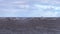 Tanker ship at sea during a storm. Tanker cargo ships on the horizon under an overcast sky. A dark cloud of stormy sky