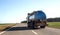 Tanker truck transporting bulk cargo on the highway, industry. Concept for the transportation of oil products and liquid food