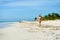 Tanned attractive woman in bikini on tropical natural beach