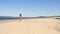 Tanned young woman running on the beach