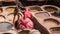 Tanner working in the dye pots at Chouara Tannery painting animal leathers, Fez, Morocco