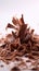 Tantalizing Macro Shot of Chocolate Shavings Unfurling from Block on White Background