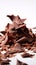 Tantalizing Macro Shot of Chocolate Shavings Unfurling from Block on White Background