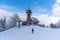 Tanvaldsky Spicak Mountain with lookout tower. Ski resort at winter time, Czech Republic