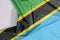 Tanzania fabric flag crepe and crease with white space.