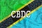 Tanzania flag with the inscription CBDC Central Bank Digital Currency and a blockchain grid around. Graphic concept for your