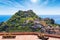 Taormina Castle and little church of Madonna della Rocca on green mount on Sicily island, Italy