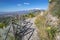 Taormina - The path among the spring mediterranean flowers and the Mt. Etna volcano