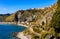 Taormina shore at Ionian sea with Castello Saraceno castle and Giardini Naxos town in Messina region of Sicily in Italy