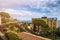 Taormina, Sicily - Beautiful view of the famous hilltop town of Taormina with palm tree, mediterranean sea