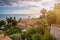 Taormina, Sicily - Beautiful view of the famous hilltop town of Taormina with palm tree, mediterranean sea