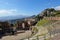 TAORMINA, SICILY - FEBRUARY 14, 2020: Teatro Antico di Taormina Ancient Amphitheatre in Sicily, Italy during sunny day with Etna