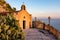 Taormina - Tourist woman in dress standing at railing of Chiesa di San Biagio of Castelmola with panoramic view on Taormina