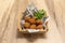 tapa of round Spanish croquettes with parsley served inside a wooden container