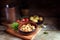 Tapas bowl with shrimps or prawns in garlic olive oil, potatoes, tomatoes and herbs on a rustic wooden table, spanish