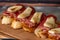 Tapas with Iberico ham, mozzarella cheese, roasted peppers on a slice of toasted baguette with olive oil