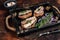 Tapas with sardine and sprat, cream cheese and onion. Dark background. Top view
