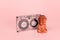 tape and Buddha figurine on a pink background. Music playlist for yoga and meditation concept. Selective focus