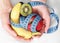 Tape measure and healthy fruits in hands representing slimming and weight loss
