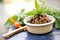 tapenade in a clay dish with a side of fresh basil