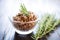 tapenade in a glass bowl with a sprig of rosemary on top