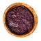 Tapenade - olive paste made from black olives. Spreadable black olive cream in wooden bowl isolated on white. Top view