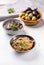 Tapenade - paste made from olives. Bowls with spreadable black and green olive cream on concrete background