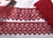 Tapes of red vinous gentle guipure, beauty lace fabric on light background