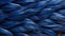 A tapestry of blue fibers twirls and weaves together to form an exquisite composition of feathers