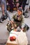 Tapestry tradesman sitting in the middle of crowded street in bazaar market. Iraq. Middle East.