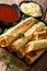taquitos with chicken and cheese close-up, as well as sauces. vertical