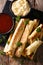 taquitos with chicken and cheese close-up, as well as sauces. Vertical top view