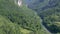 Tara canyon bridge Durdevica above Tara river Montenegro. Tilting camera motion through Tara canyon along river between