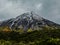 Taranaki or mount egmont vulcano with snow in cloudy evening