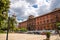 Taranto, Italy - May 7, 2018: Square of Giardini Piazza Garibaldi and old building, street lights, palm trees in front of blue sky