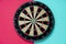 Target dart board on the red and table background, center point, head to target marketing and business success concept