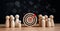 Target and goal concept, Wooden figures standing around dartboard and arrow for creative and set up business objective target goal