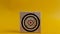 Target icon on wooden cubes, yellow background. Target concept