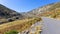 Tarmac road AV-931 with red and white making poles in Sierra de Gredos mountains, Spain.